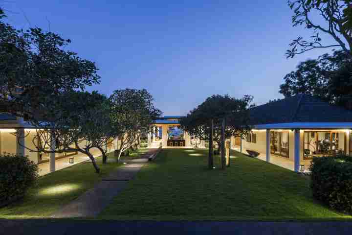 Arial view of Uluwatu estate grounds at night, luxury Balinese accommodation