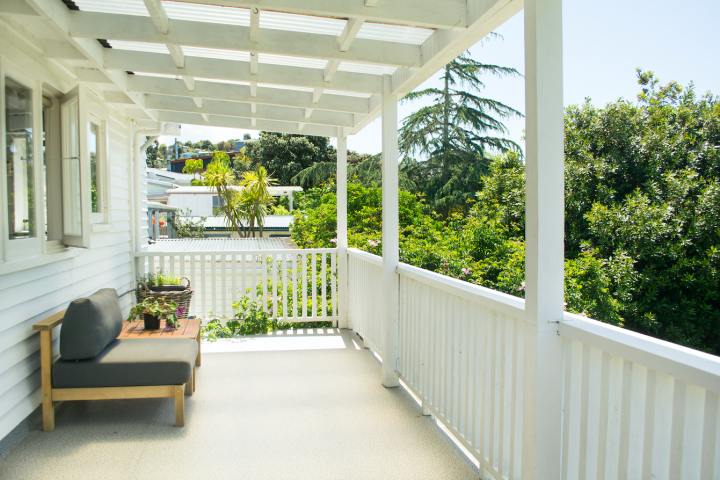 Spacious sunny balcony deck area with outdoor furniture