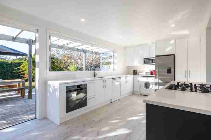 Driftwood Beach House Open plan kitchen leads onto the deck