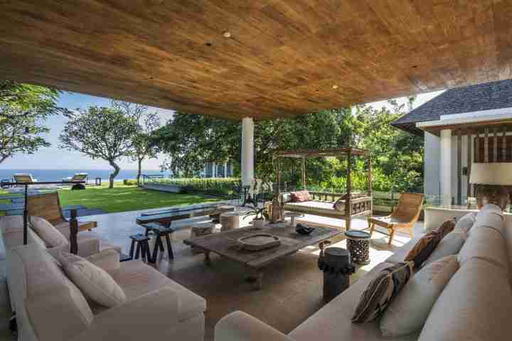 Outdoor entertainment area with view of infinity pool at luxury estate Uluwatu