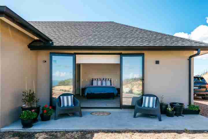 Entrance to Te Whau apartment with outdoor seating, luxury Waiheke accommodation