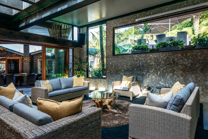 Formal lounge room with open-plan dining area at Kauri Springs lodge, corporate events Waiheke