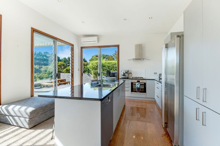Fully-equipped self-catered kitchen with Nespresso Coffee Machine in spacious Waiheke family home