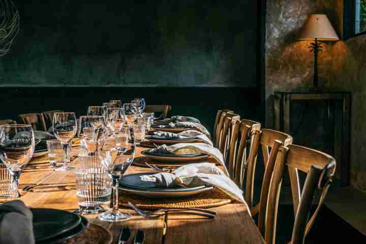 The Lodge dinning table with artistic wooden chairs and place-settings