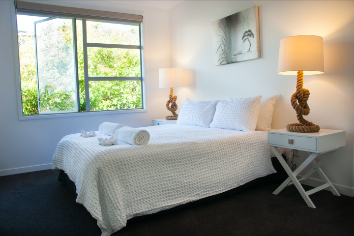 Condo on the beach sunny master bedroom with large windows