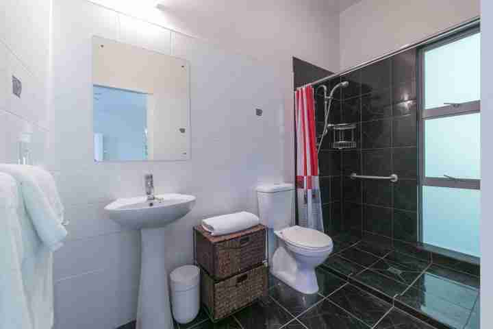 Walk in shower of modern ensuite bathroom of Ted's Cottage