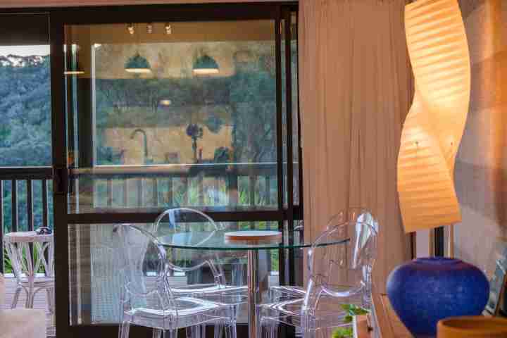 The Pavilion Omiha Dining area with ghost chairs and designer lamp