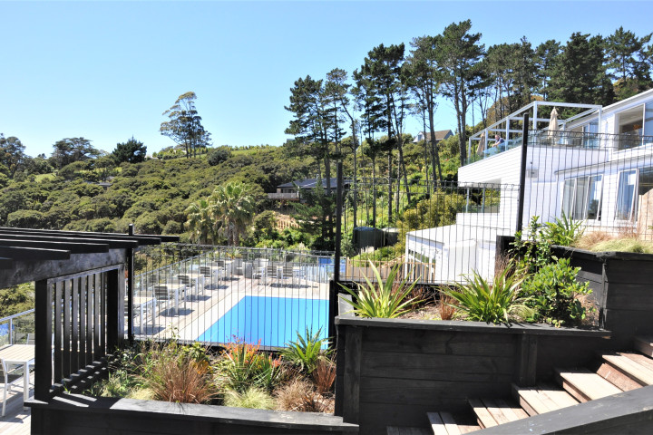 Large outdoor swimming pool with loungers and sea view at The Resort
