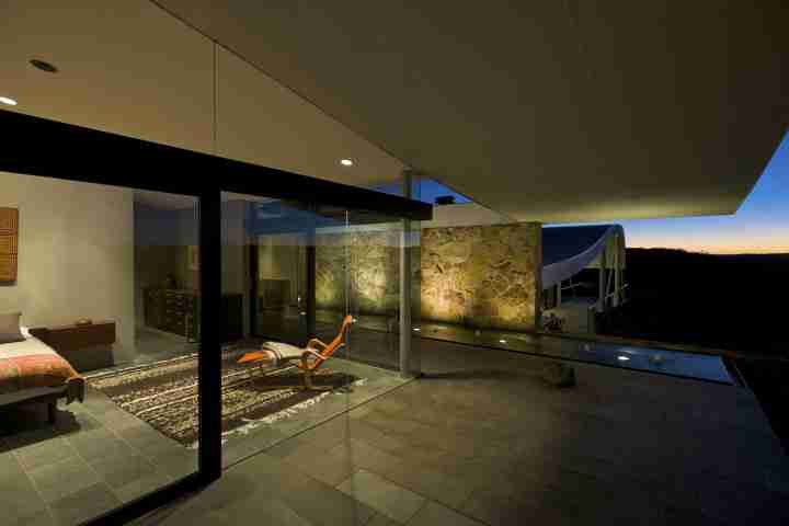 Bedroom with glass front and expansive views of Australian bush at the iconic Seidler House, private contemporary luxury holiday accommodation in Australia Southern Highlands