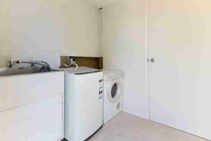 Fully-equipped laundry facilities including washing machine and dryer, catering for your Waiheke escape