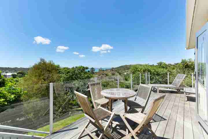 Large outdoor balcony deck with seating and expansive Island views