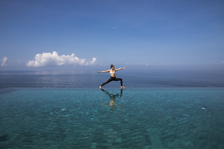 Yoga at infinity pool in luxury Bali accommodation in private estate, Uluwatu