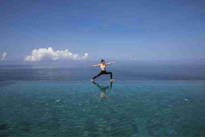 Yoga at infinity pool in luxury Bali accommodation in private estate, Uluwatu